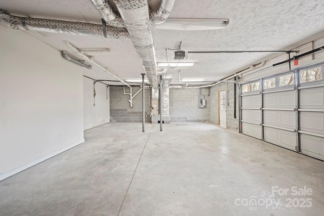 garage with a garage door opener and electric panel