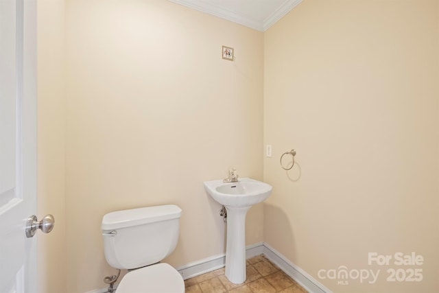 bathroom featuring crown molding, toilet, and sink