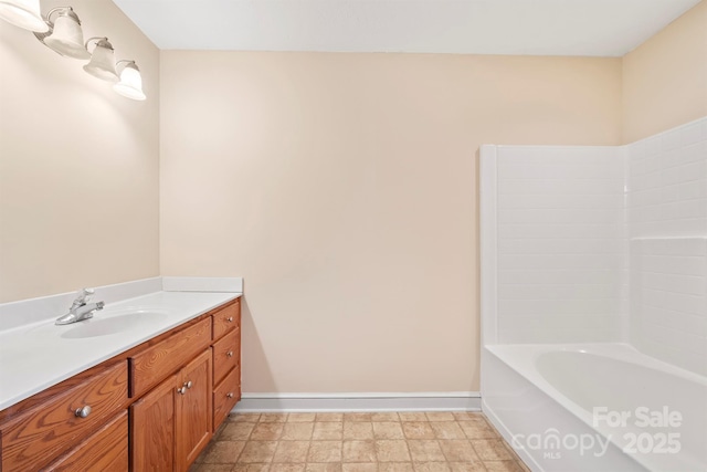 bathroom with vanity and a tub