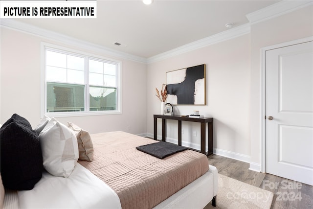 bedroom featuring hardwood / wood-style floors and ornamental molding