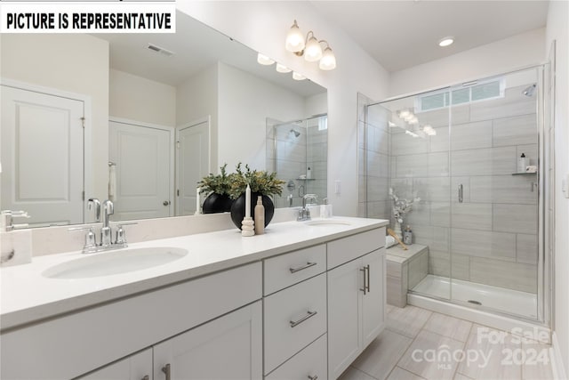 bathroom featuring tile patterned flooring, vanity, and an enclosed shower