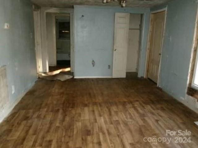 spare room with dark hardwood / wood-style flooring