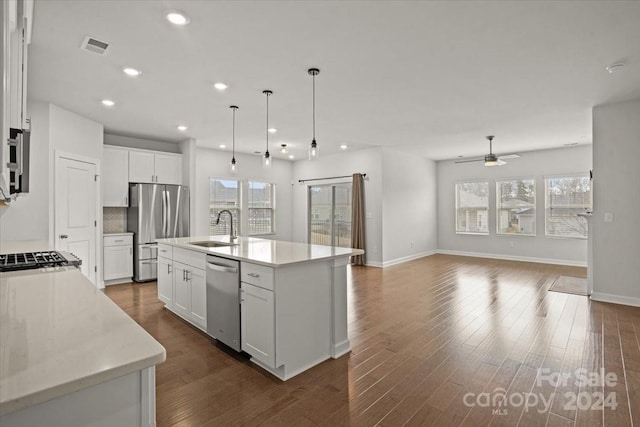 kitchen with a center island with sink, white cabinets, sink, ceiling fan, and stainless steel appliances