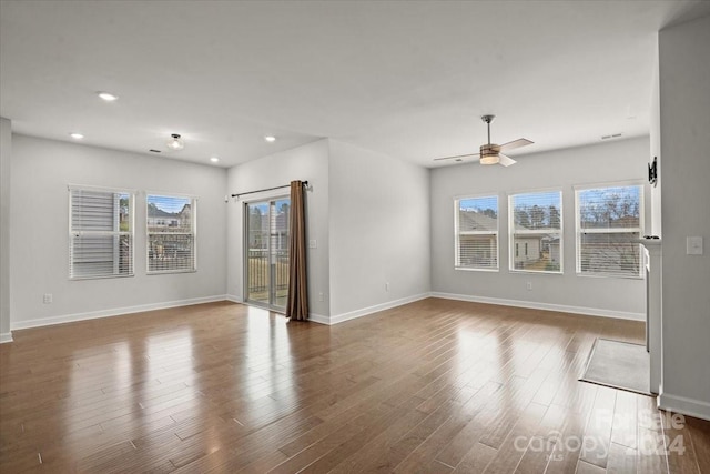 unfurnished living room with ceiling fan and hardwood / wood-style floors