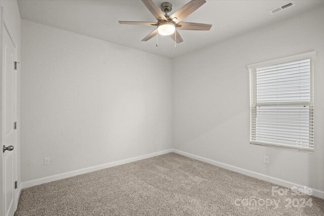 spare room with carpet flooring and ceiling fan