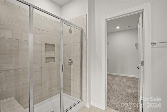 bathroom with a shower with shower door