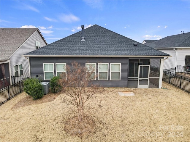 rear view of property with central AC and a sunroom