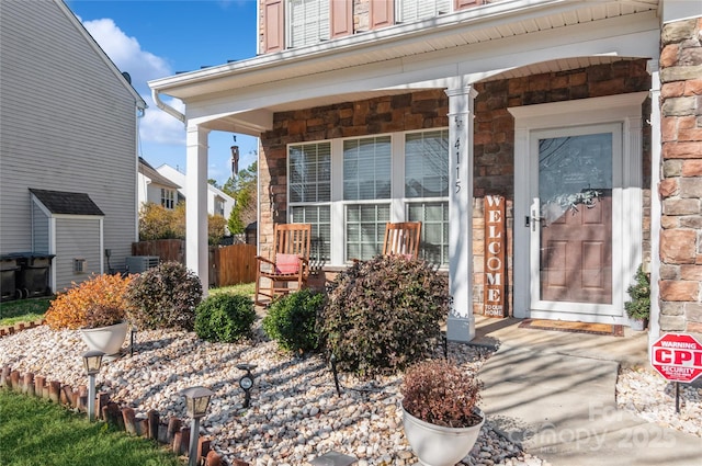 entrance to property with covered porch and central AC