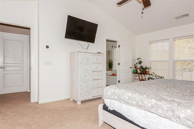 carpeted bedroom featuring ceiling fan, ensuite bath, and vaulted ceiling