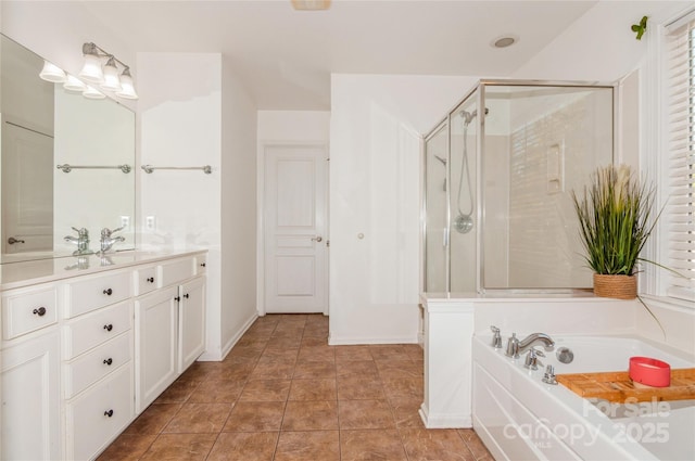 bathroom with tile patterned floors, vanity, and separate shower and tub