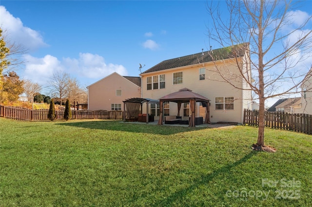 back of property with a gazebo and a yard