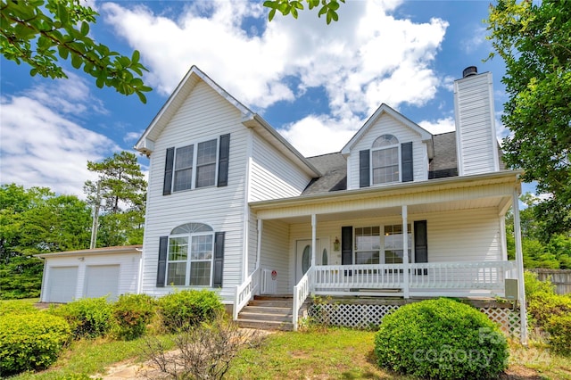 view of front of home featuring covered porch and a garage