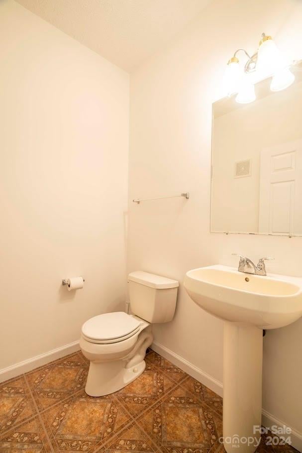 bathroom with toilet and sink