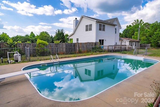 view of pool featuring a diving board