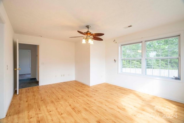 spare room featuring light wood-type flooring and ceiling fan