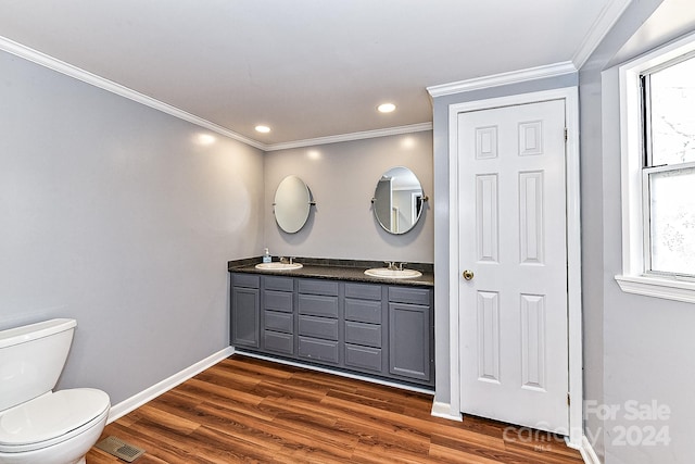 bathroom featuring hardwood / wood-style floors, vanity, ornamental molding, and toilet