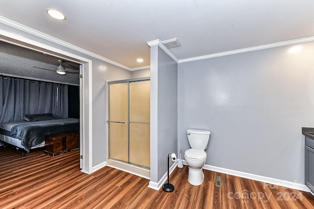 bathroom with crown molding, an enclosed shower, toilet, vanity, and hardwood / wood-style flooring