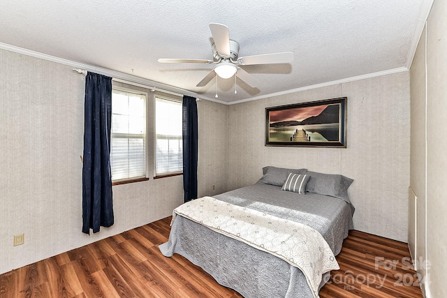 bedroom with dark hardwood / wood-style floors, ceiling fan, ornamental molding, and a textured ceiling