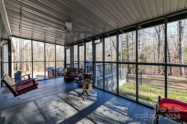 sunroom featuring a wealth of natural light and ceiling fan