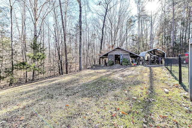 view of yard featuring a carport and an outdoor structure