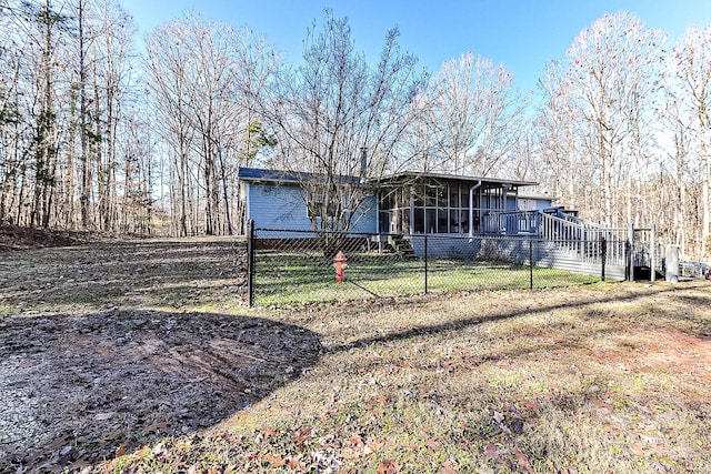 back of house featuring a sunroom and a yard