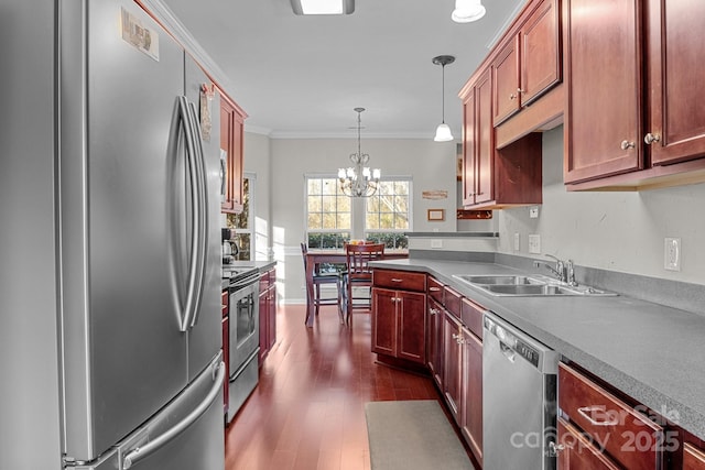 kitchen featuring sink, stainless steel appliances, an inviting chandelier, decorative light fixtures, and ornamental molding