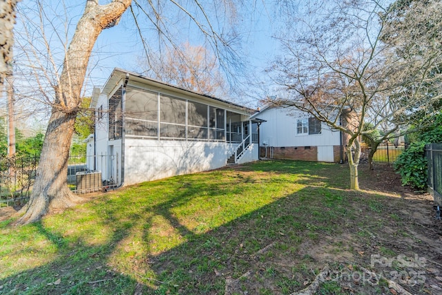 view of front of home with a front lawn and a sunroom