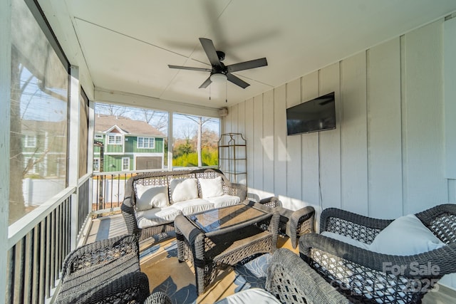 sunroom featuring ceiling fan