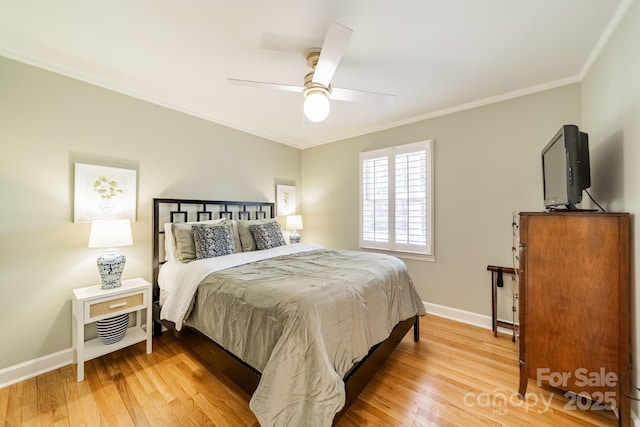 bedroom featuring hardwood / wood-style floors, ceiling fan, and ornamental molding