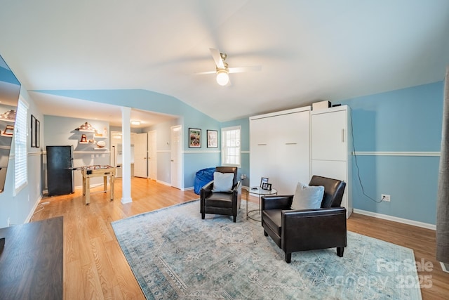 sitting room with hardwood / wood-style floors, ceiling fan, and lofted ceiling