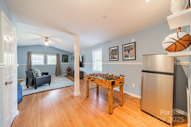 recreation room featuring ceiling fan, vaulted ceiling, and light wood-type flooring