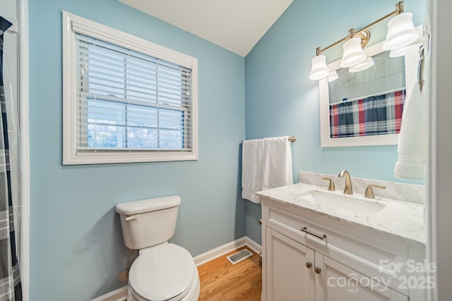 bathroom featuring a shower with shower curtain, hardwood / wood-style floors, vanity, and toilet