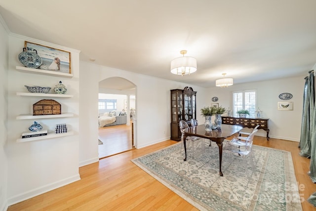 dining area featuring hardwood / wood-style floors and an inviting chandelier