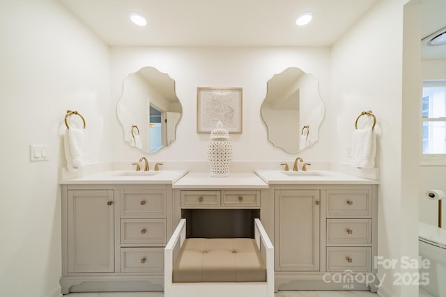 bathroom featuring vanity and toilet