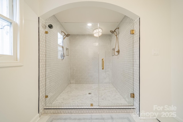 bathroom with a shower with shower door