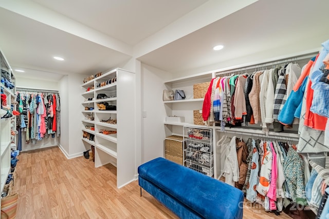 spacious closet with light hardwood / wood-style floors