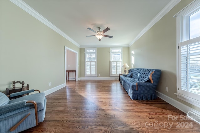 living area with crown molding, ceiling fan, and dark wood-type flooring