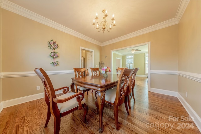 dining area featuring ceiling fan with notable chandelier, hardwood / wood-style flooring, and ornamental molding