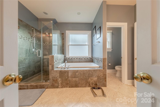 bathroom featuring separate shower and tub, tile patterned flooring, and toilet