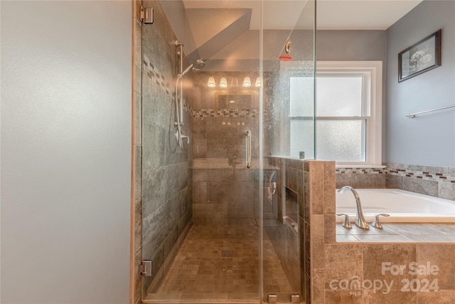 bathroom featuring separate shower and tub