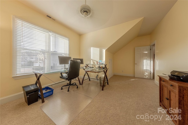 home office featuring light carpet and vaulted ceiling