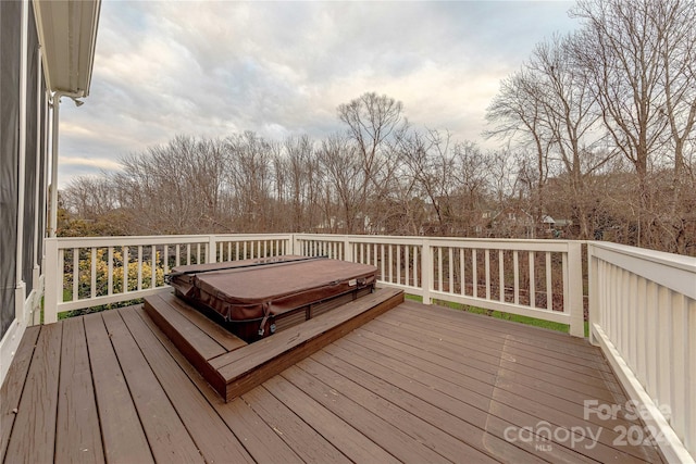 deck with a covered hot tub