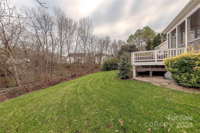 view of yard featuring a deck and a sunroom