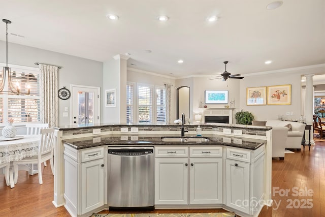 kitchen featuring pendant lighting, sink, stainless steel dishwasher, ceiling fan, and white cabinetry