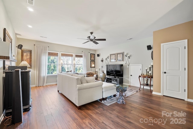 living room with dark hardwood / wood-style floors and ceiling fan