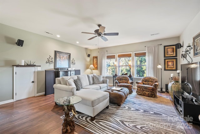 living room featuring dark hardwood / wood-style flooring and ceiling fan