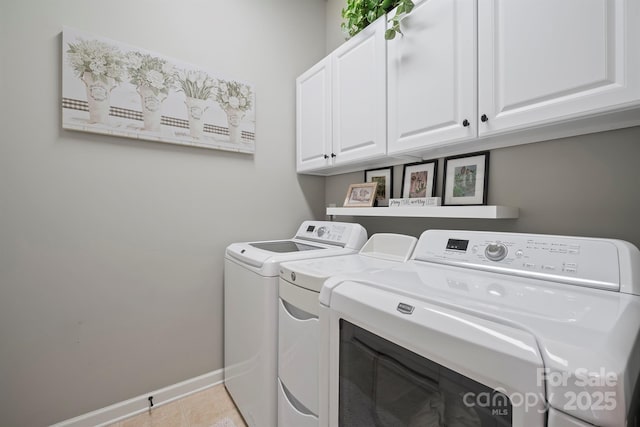 washroom with cabinets, separate washer and dryer, and light tile patterned floors