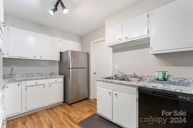 kitchen with dishwasher, sink, light hardwood / wood-style floors, white cabinetry, and stainless steel refrigerator