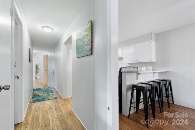 hallway with light hardwood / wood-style floors