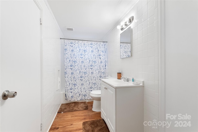 full bathroom featuring vanity, crown molding, toilet, shower / bath combo with shower curtain, and wood-type flooring